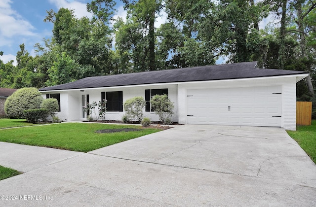 single story home with a front yard and a garage