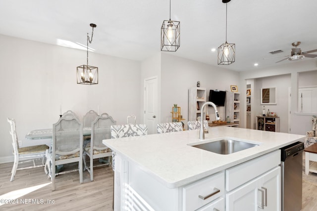 kitchen with white cabinetry, sink, a center island with sink, and light hardwood / wood-style flooring