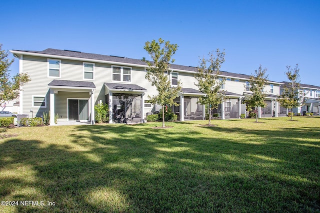 rear view of property with a yard