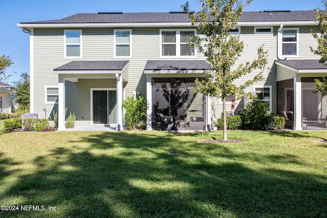 rear view of property with a lawn