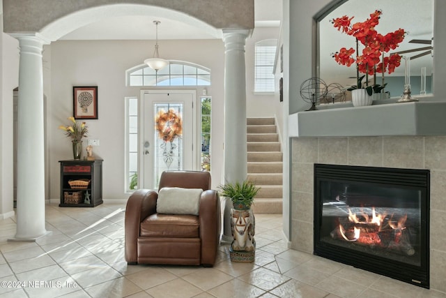 interior space featuring a tile fireplace and light tile patterned flooring