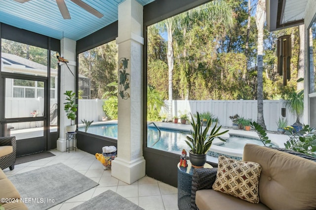 sunroom / solarium featuring ceiling fan and a wealth of natural light