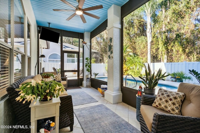 sunroom / solarium featuring ceiling fan