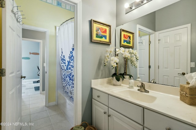 bathroom featuring tile patterned flooring, shower / bath combo, and vanity