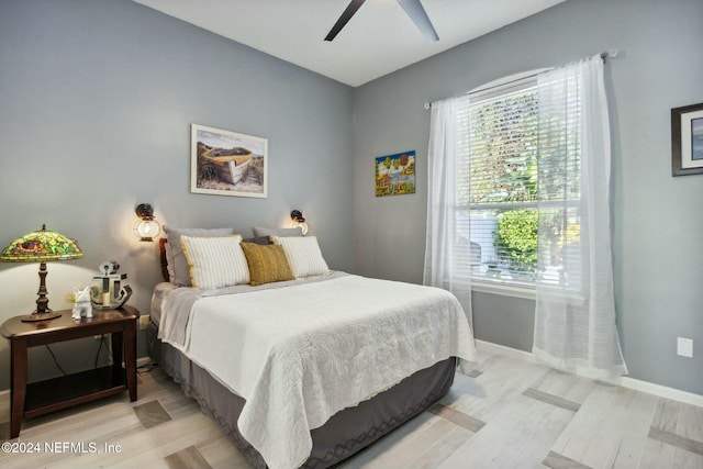 bedroom with ceiling fan and light hardwood / wood-style floors