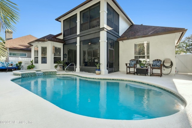 back of property featuring a swimming pool with hot tub and a patio area