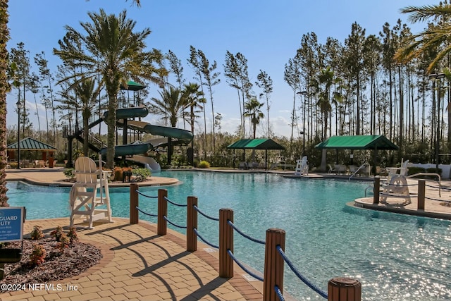 view of swimming pool featuring a patio area and a water slide