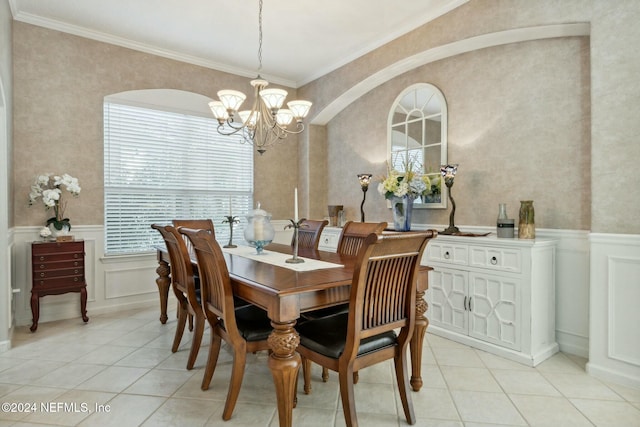 dining room featuring light tile patterned flooring, a chandelier, and ornamental molding