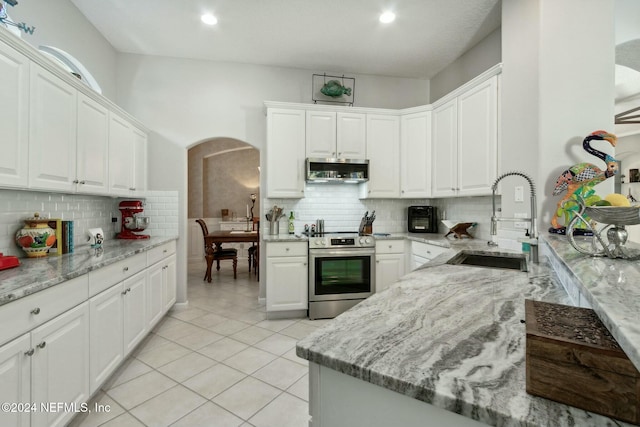 kitchen with light stone countertops, white cabinetry, sink, and stainless steel appliances