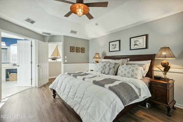 bedroom with hardwood / wood-style floors, ceiling fan, and a textured ceiling