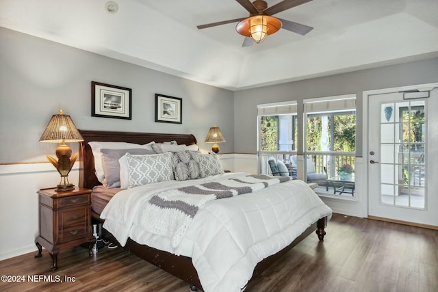 bedroom with a raised ceiling, ceiling fan, access to exterior, and dark wood-type flooring