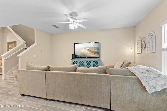 living room with light hardwood / wood-style floors and ceiling fan