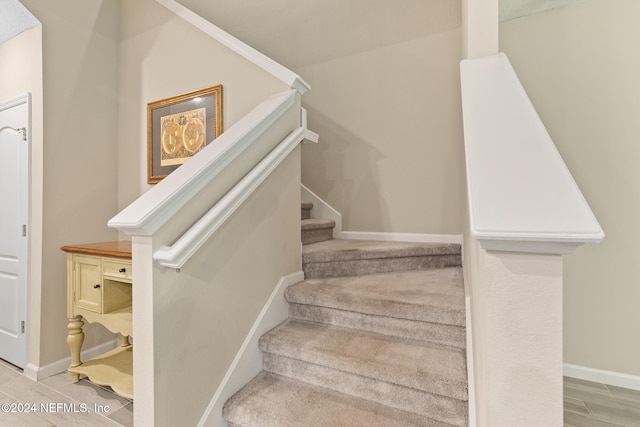 staircase featuring wood-type flooring