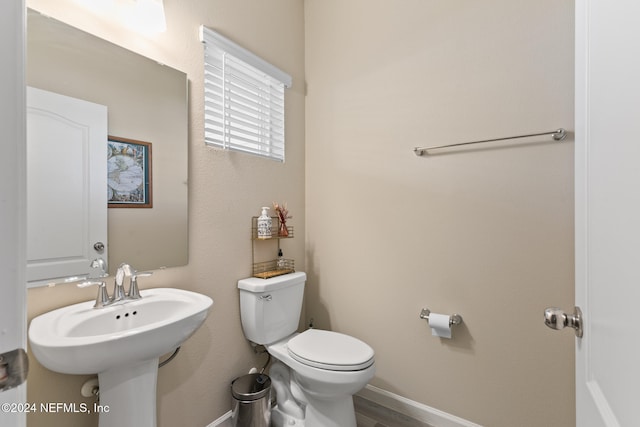 bathroom featuring hardwood / wood-style floors and toilet