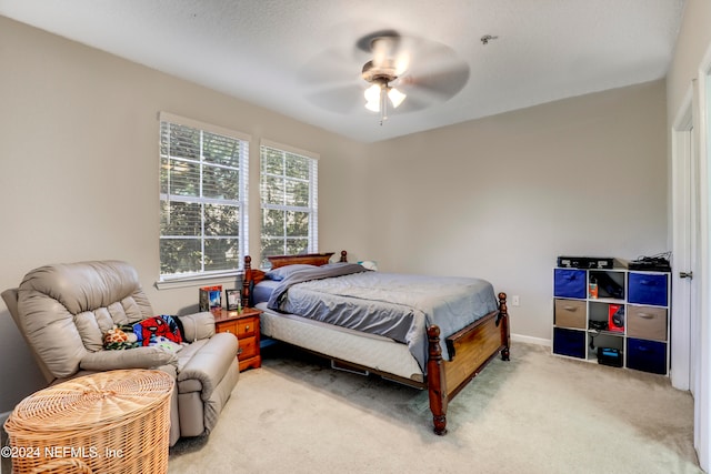 bedroom featuring ceiling fan and light carpet