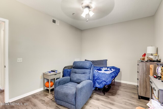 sitting room featuring ceiling fan and light hardwood / wood-style flooring