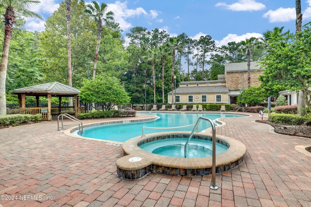 view of pool featuring a gazebo, a community hot tub, and a patio