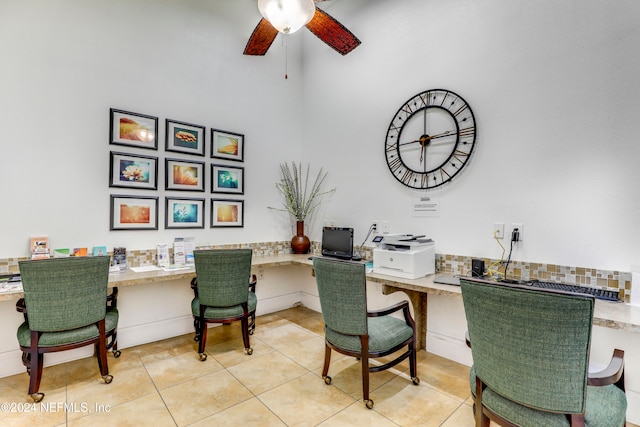 office featuring ceiling fan, light tile patterned floors, and built in desk