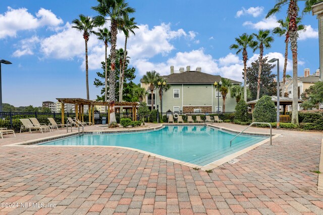 view of swimming pool featuring a pergola and a patio