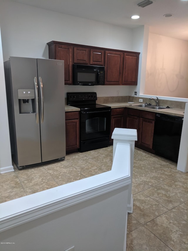 kitchen with sink, light tile patterned floors, and black appliances