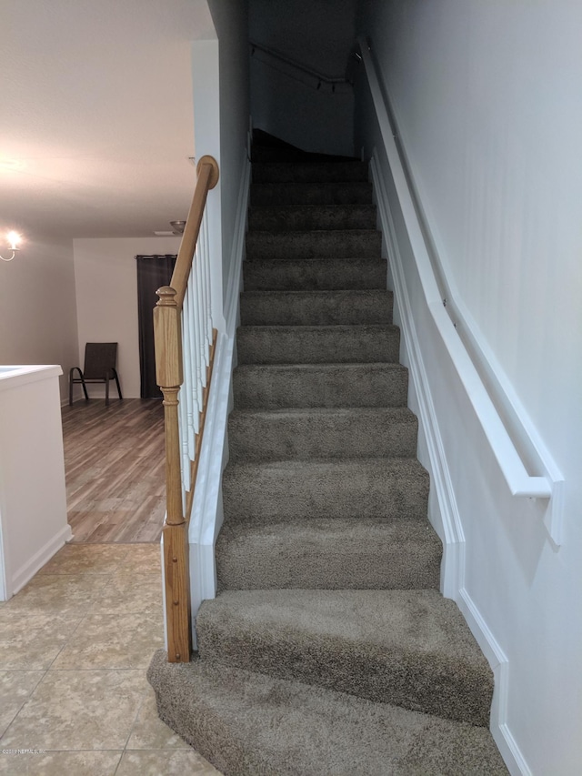 stairway with hardwood / wood-style floors