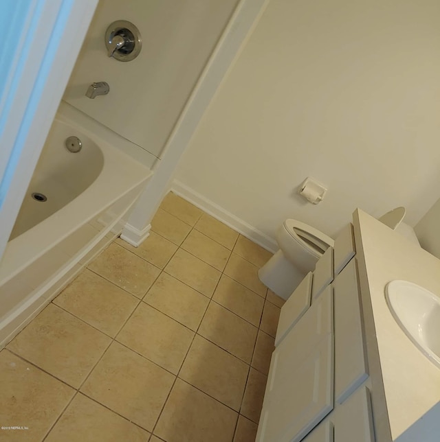 bathroom with tile patterned flooring, vanity, and toilet