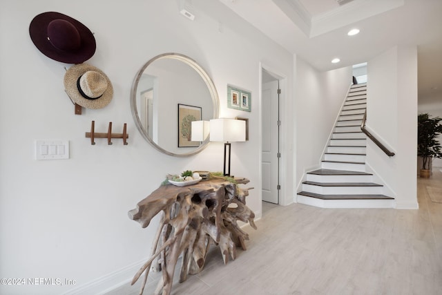 interior space with light wood-type flooring and crown molding