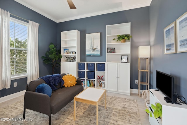 living room with ceiling fan, crown molding, and light hardwood / wood-style flooring