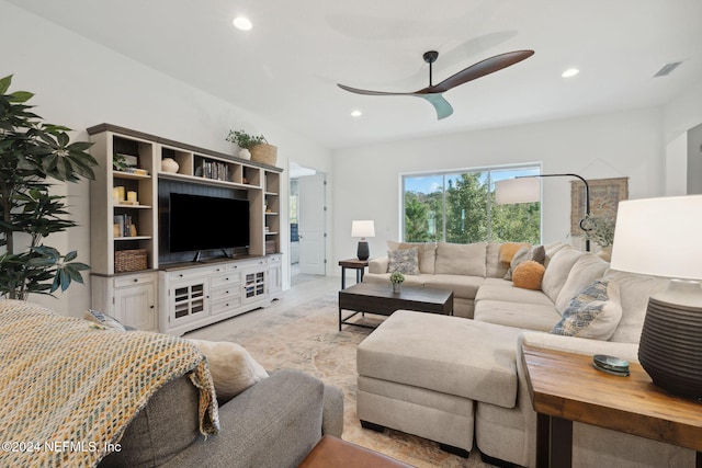 carpeted living room with ceiling fan