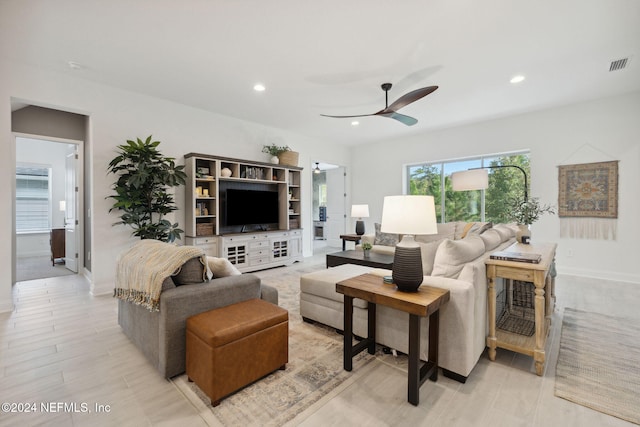 living room featuring ceiling fan and light hardwood / wood-style flooring