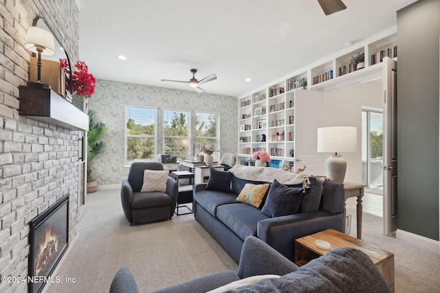 carpeted living room featuring a fireplace, a textured ceiling, and ceiling fan