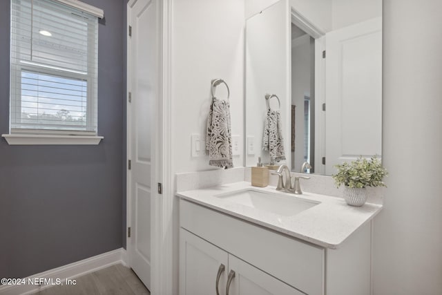 bathroom with vanity and hardwood / wood-style flooring