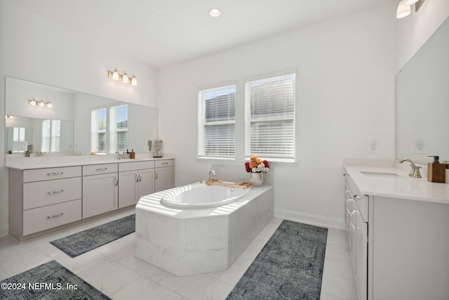 bathroom featuring vanity and tiled bath