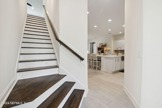 stairs with wood-type flooring