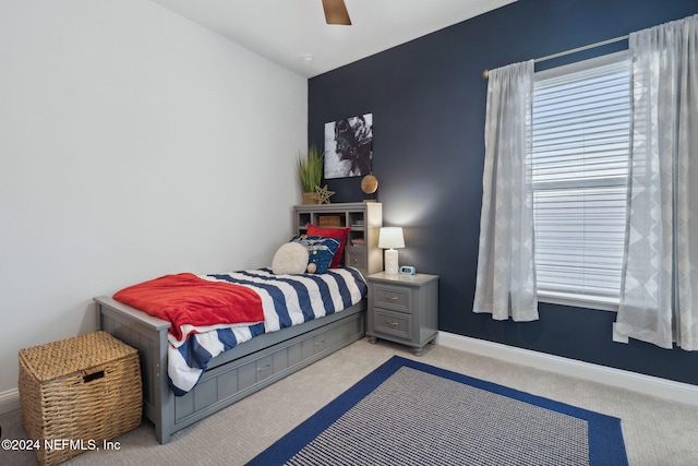 bedroom featuring light carpet and ceiling fan