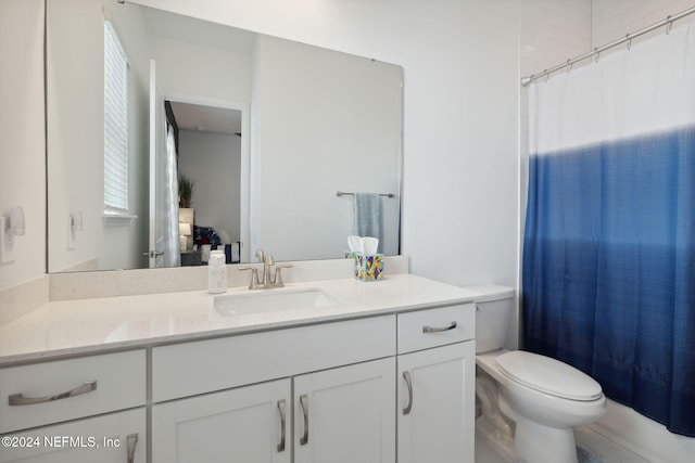 full bathroom featuring vanity, shower / tub combo, and toilet