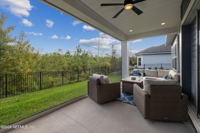 sunroom / solarium featuring ceiling fan