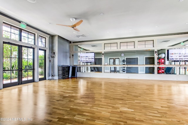 exercise room featuring ceiling fan and hardwood / wood-style flooring