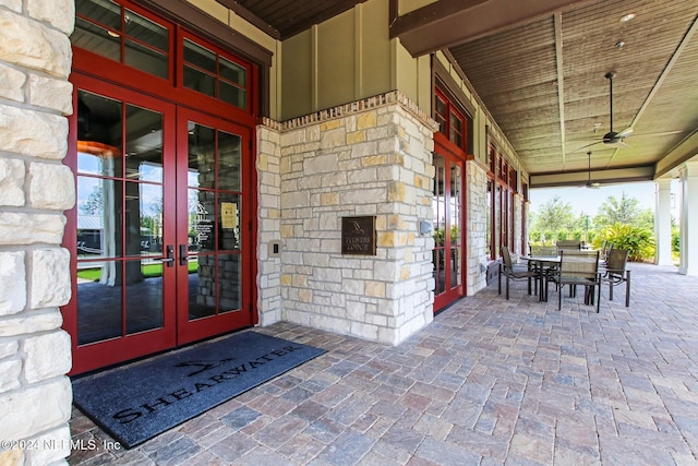 doorway to property featuring ceiling fan and french doors