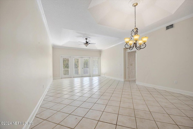 tiled empty room with a textured ceiling, ceiling fan with notable chandelier, a tray ceiling, and crown molding