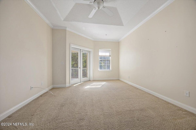 empty room featuring light carpet, french doors, ceiling fan, ornamental molding, and a textured ceiling