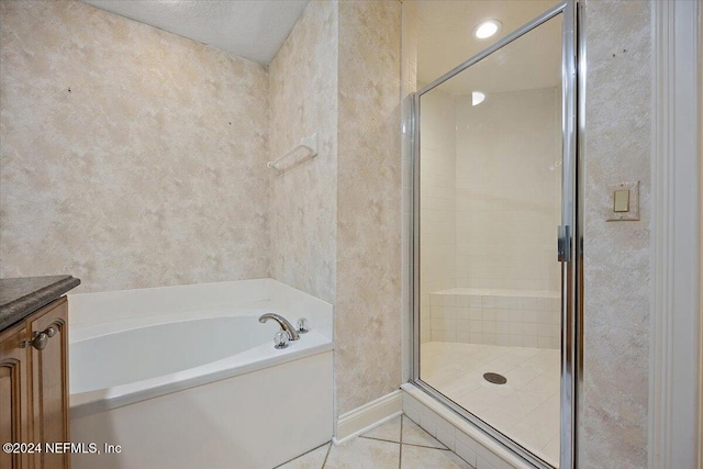 bathroom with vanity, shower with separate bathtub, a textured ceiling, and tile patterned floors