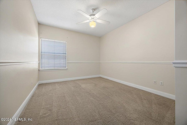 spare room with ceiling fan, carpet floors, and a textured ceiling