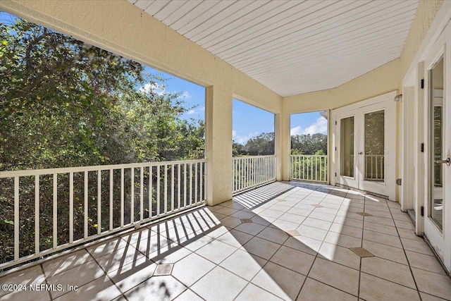 unfurnished sunroom with french doors