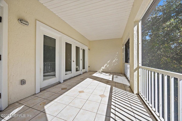 unfurnished sunroom featuring french doors