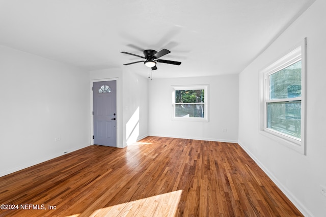 spare room featuring wood-type flooring and ceiling fan