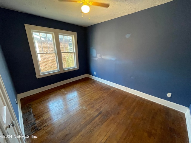 spare room featuring a textured ceiling, hardwood / wood-style flooring, and ceiling fan