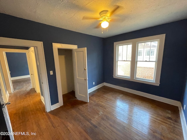 unfurnished bedroom featuring a textured ceiling, hardwood / wood-style flooring, and ceiling fan