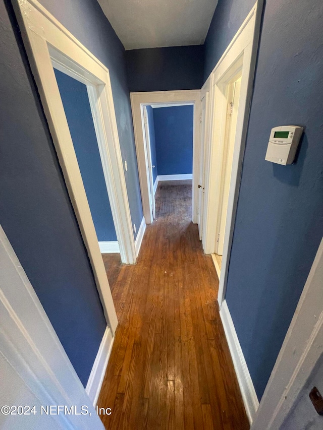 hallway featuring dark wood-type flooring