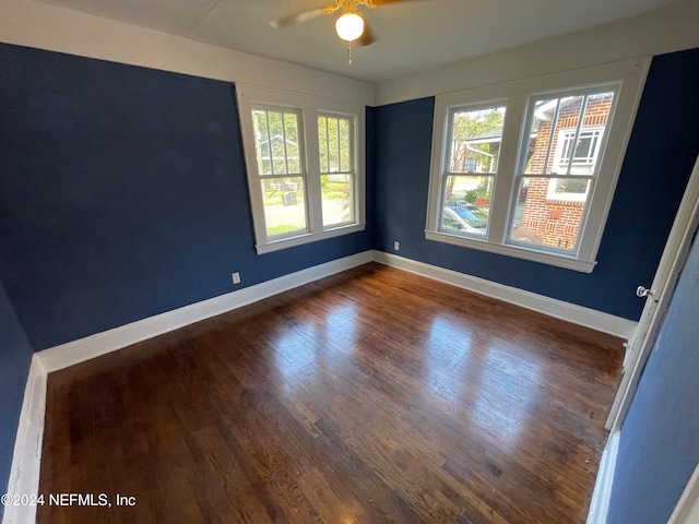 spare room featuring ceiling fan and dark hardwood / wood-style flooring